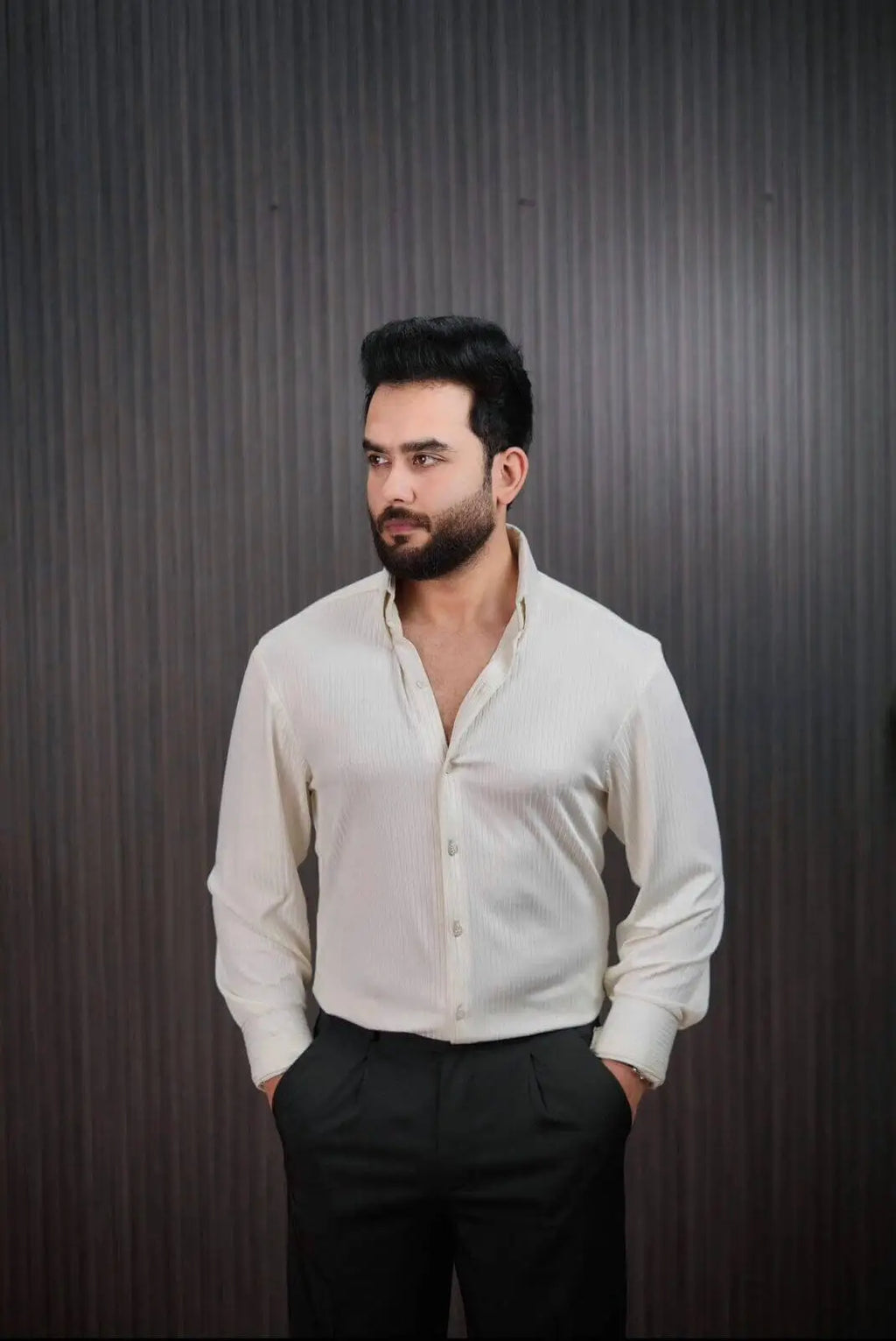 Men styling ivory pinstripe shirt with black dress pants