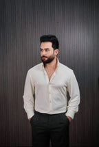 Men styling ivory pinstripe shirt with black dress pants
