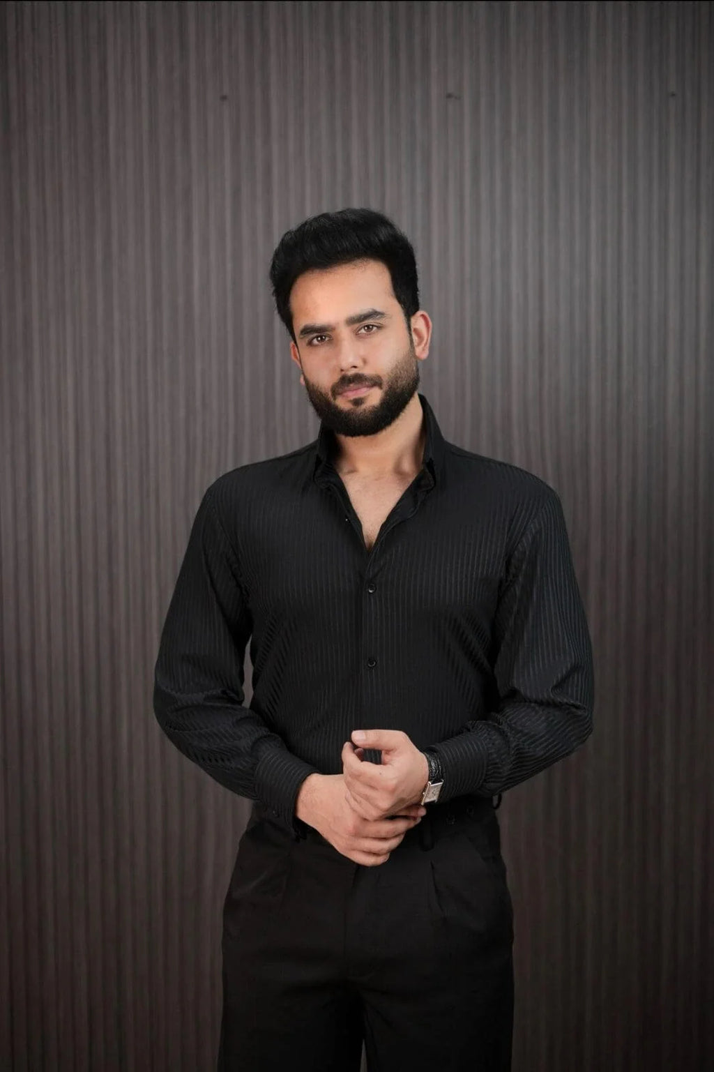 Men styling black slim fit pinstripe shirt with dress pants