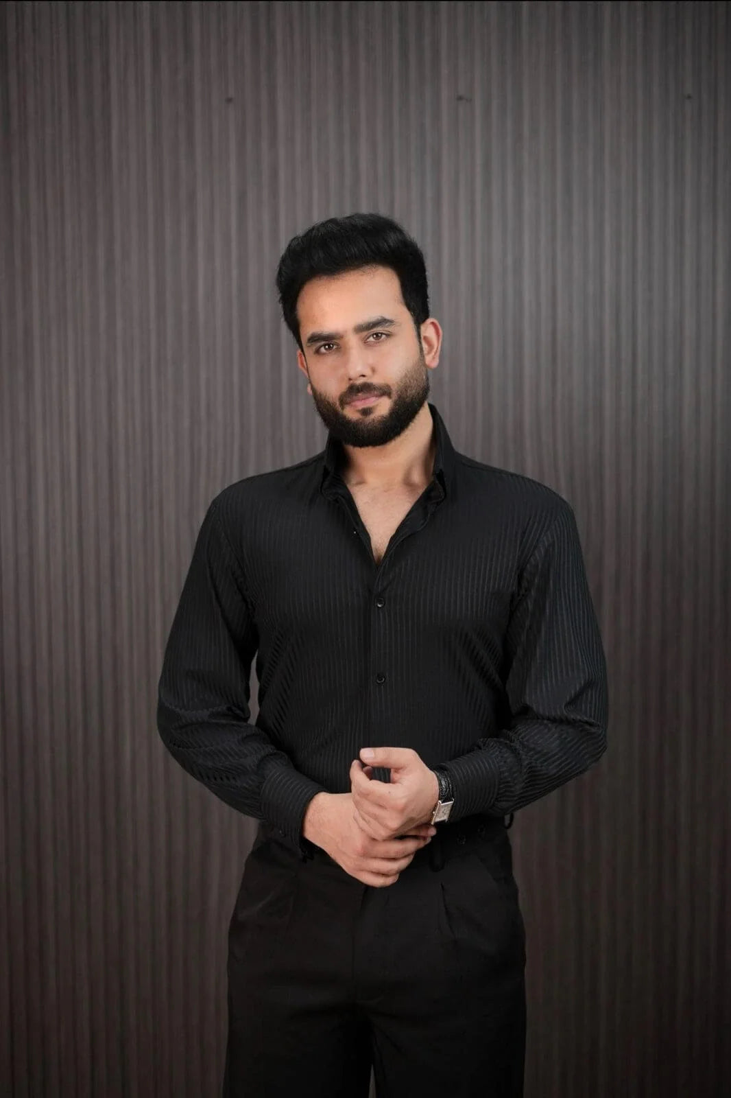 Men styling black slim fit pinstripe shirt with dress pants